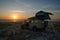 4x4 offroad vehicle with roof top tent camping on beach during sunset, Casamance, Senegal, Africa