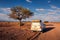 4x4 rental car equipped with a roof tent driving on a dirt road in Namibia