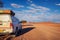 4x4 rental car equipped with a roof tent parks on a dirt road in Namibia