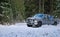 4x4 truck drifting on winter snow road in forest