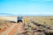 A 4x4 vehicle driving on a dirt road in the Karoo