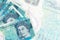 5 British pounds bills lies in stack on background of big semi-transparent banknote. Abstract business background