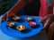 5 Lit diyas placed on a plate for dewali celebration in india