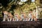 5 puppies of red New Year`s Akita dogs sitting on stairs in nature