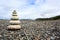 5 Sea urchin shells stacked on pebble beach