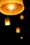 5 Thai lanterns floating in the dark sky