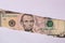 5 US dollar banknote in torn paper hole