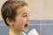 A 5-year-old boy at home washes his teeth with an oral irrigator. Little boy cleaning teeth with oral irrigator. Dental Care