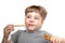 5 years old boy eats bread sticks on white background, crispy snack with poppy seeds