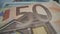 50 euro bill in close up shot with many details as watermarks, european union sign, blue star as symbol of EU. The blue