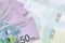 50 Israeli new shekels bills lies in stack on background of big semi-transparent banknote. Abstract business background