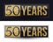 50 years anniversary gold banner on dark and white backgrounds.