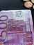 500 euro banknote and metal coins of five, ten, twenty, fifty cents on a dotted black background,