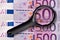 500 euros banknotes and magnifying glass