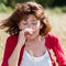 50s woman having hay fever allergies in dry meadows