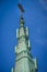 5g cell phone antennas on the oxidized copper gable of a cathedral