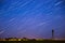5k Timelapse Amazing Unusual Stars Effects In Sky. Stars Lines Move Above Rural Landscape Water Tower In Background