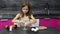 A 6-7 year old girl tells and shows how to make an omelet with sausage