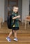 6 or 7 years old female child smiling happy smiling cheerful carrying big heavy school backpack wearing young girl student unifor