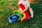 6 month old baby using to play a wooden rainbow puzzle, improving his skills, view from above