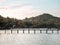 6 oct 20, Koh Kut Island, Thailand. workers walking on wooden bridge over the sea near tropical beach resort. sunrise in the morni