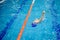 A 6-year boy swims in a swimming pool