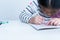 A 6 year old Asian girl, are concentrating on making card for mothers on important occasions