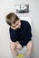 6 year old boy sitting on the toilet