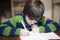 6-year-old child performs homework