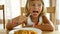 6 year old girl eating spaghetti.