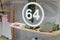 64 sign and logo number front of fashion clothes store from basque country in