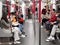 7 2 2021 people with face masks in spacious public subway train MTR during covid-19 in Hong Kong, China, most people playing