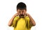 7 or 8 years old male child crying helpless and sad isolated on white background wearing yellow t-shirt in kid scolded and nagged