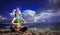 7 chakras. A woman meditates in the lotus position on the background of dark night blue sky and sea. The concept of harmony and