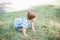 7 month child crawls on grass in yard