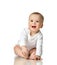 7 month infant child baby girl toddler sitting in white shirt isolated