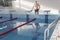 A 70-year-old pensioner is resting, swimming, recovering in the pool with clear and blue water in the hotel