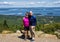 75 year-old caucasian male and his 64 year-old Korean wife atop Cadillac Mountain near Bar Harbor, Maine.