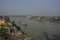 7th January, 2021. Namkhana, West Bengal, India. Colorful wooden fishing boats floating on matla river at Namkhana and few houses