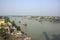 7th January, 2021. Namkhana, West Bengal, India. Colorful wooden fishing boats floating on matla river at Namkhana and few houses