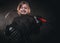 8-10 year old smiling hockey player posing in uniform for a photoshot in a dark studio