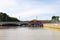 8 3 2023 trees, boat and building along Sungai Kedayan river, the capital of Brunei Darussalam in sunny day with white coulds and