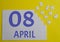 8 april calendar date on a white puzzle with separate details. Puzzle on a yellow background with a blue inscription