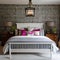 8 A cozy, cottage-style bedroom with a mix of patterned and solid bedding, a white wooden bed frame, and a statement chandelier2