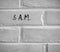 8 A.M. WRITTEN ON WHITE PLAIN BRICK WALL