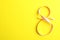 8 March, International Women`s Day. Figure eight of pink ribbon on yellow background