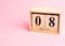 8 march wooden calendar on the pink background. Womens day concept. Copy space, close up, minimalism