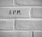 8 P.M. WRITTEN ON WHITE PLAIN BRICK WALL