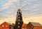 8 sail windmill in England with red brick property