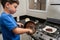 8 year old in the kitchen, fingering the pan with brigadeiro, a Brazilian sweet